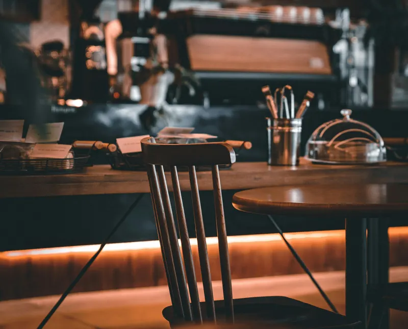 Wooden chair and table in front of the coffee counter